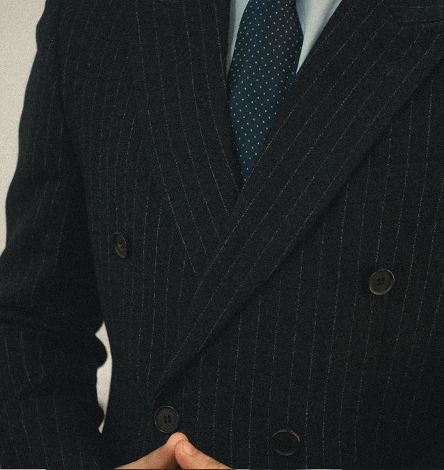 Close-up of a navy pinstripe double-breasted corporate blazer