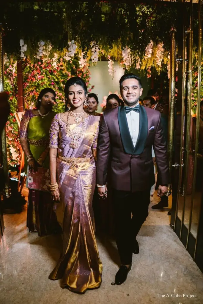 Bride and groom walking in coordinated Aayra wedding outfits