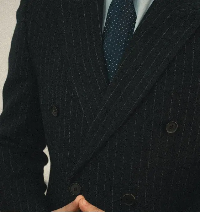 Close-up of a navy pinstripe double-breasted corporate blazer