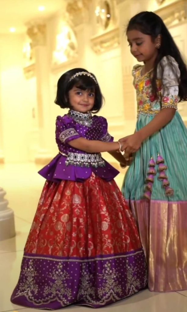 Two young sisters in Aayra pattu paavadai and a festive lehenga