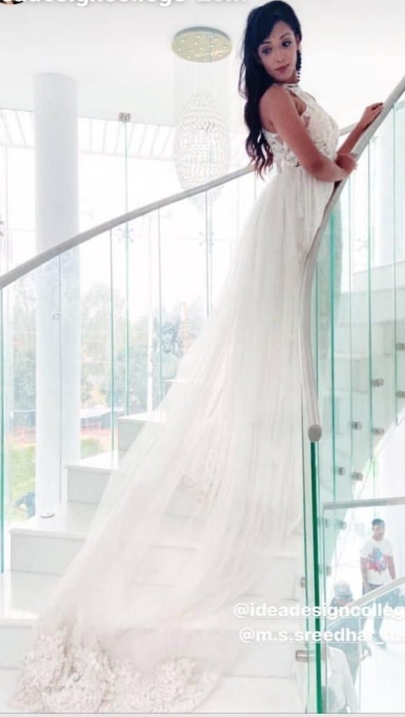 Woman in a white corset gown on a staircase
